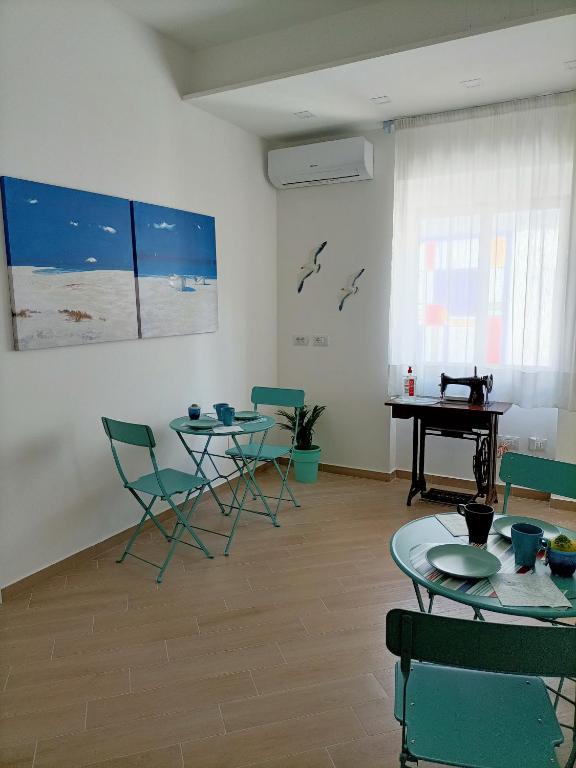 a room with tables and chairs and a piano at Il vicolo di Clara B&B in Diamante