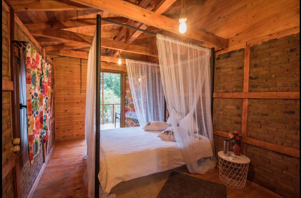 a bedroom with a canopy bed in a wooden cabin at Otantik Tas Ev in Dalaman