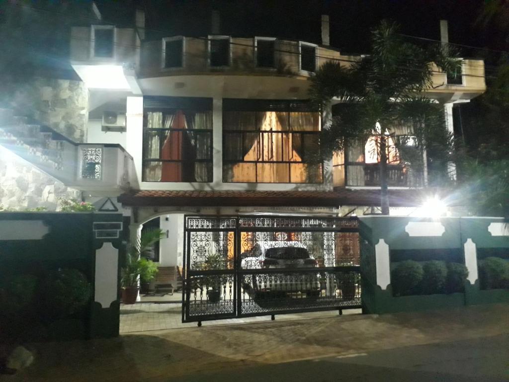 a building with a gate in front of it at night at Basilico Homestay in Kegalle