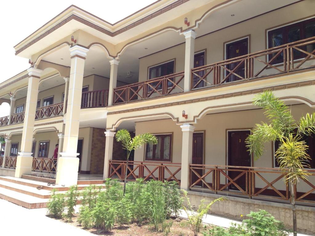 ein Gebäude mit Balkonen und Bäumen davor in der Unterkunft Lebijou Guesthouse - Konesavath in Don Det