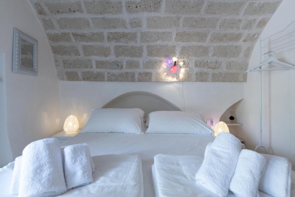 Postel nebo postele na pokoji v ubytování B&B Trulli Moonlight da Grace