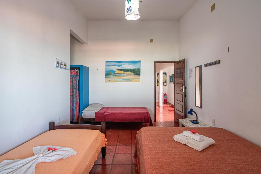 a room with two beds and a hallway at casa Mirage Pipa in Pipa