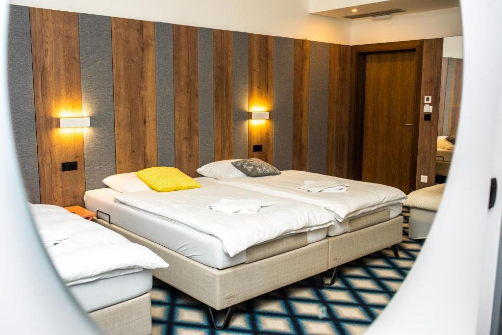 A bed or beds in a room at Swiss Plus Hotel