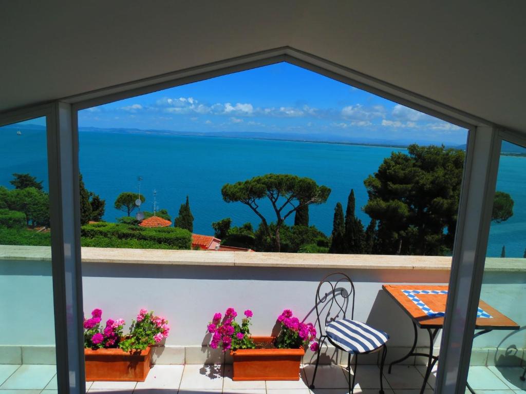 a view of the ocean from the balcony of a house at Villa Noi Quattro in Porto Santo Stefano