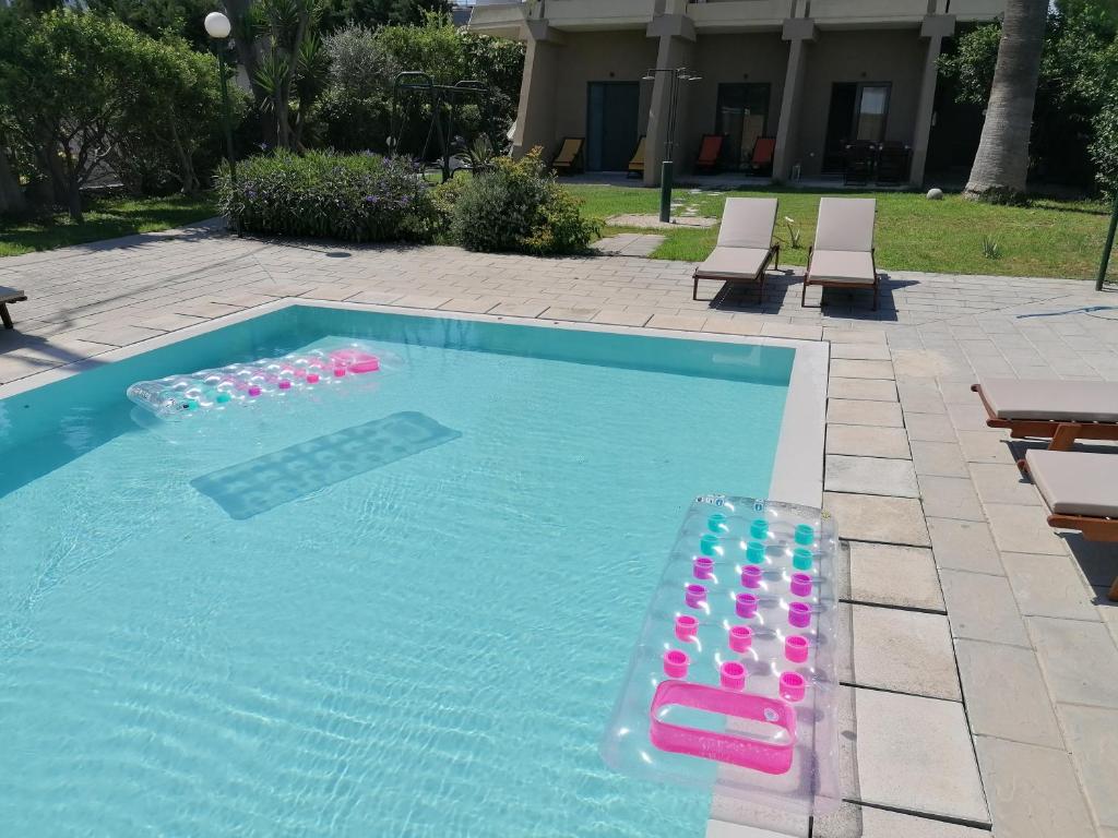 a swimming pool with a bunch ofogie boards in it at Endless Summer Pool Flat in Ixia