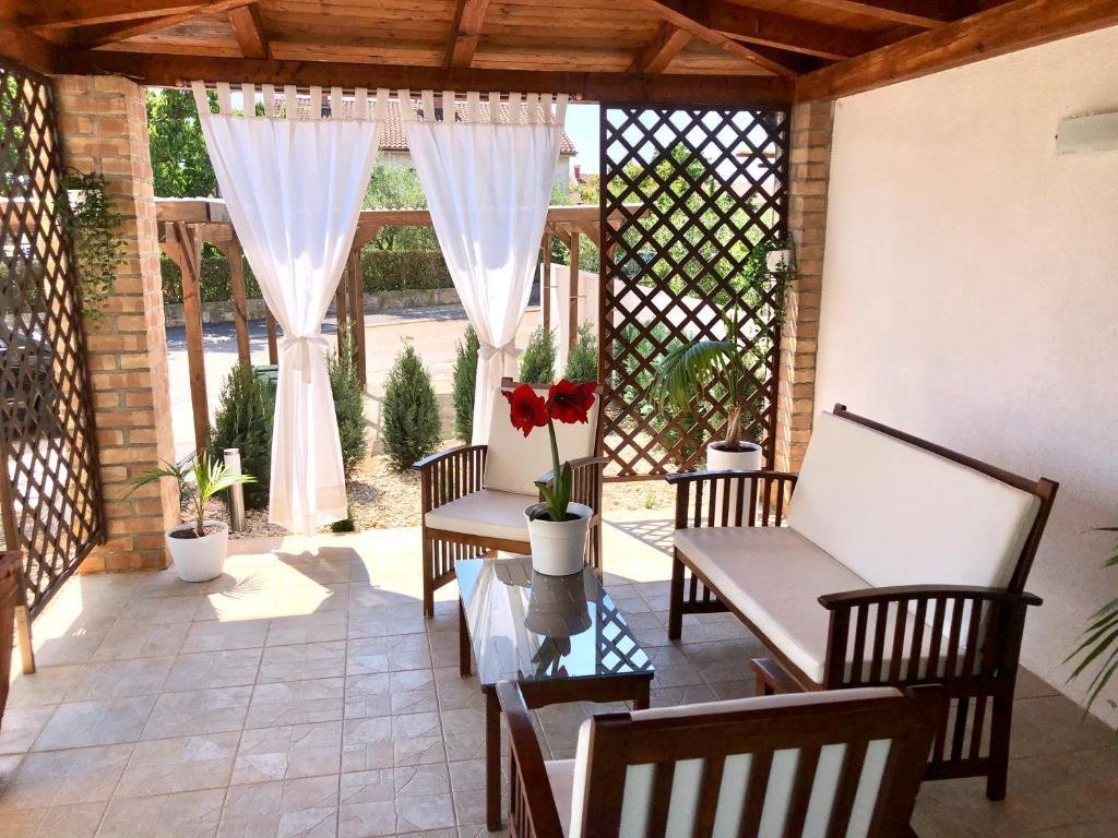 a patio with a table and chairs and a window at Apartments Roberta in Novigrad Istria