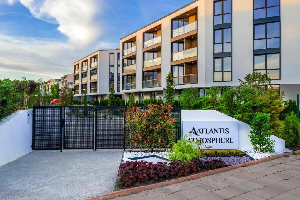 an apartment building with a sign that reads atantis apartments and architecture at Atlantis Atmosphere Apartment in Burgas City