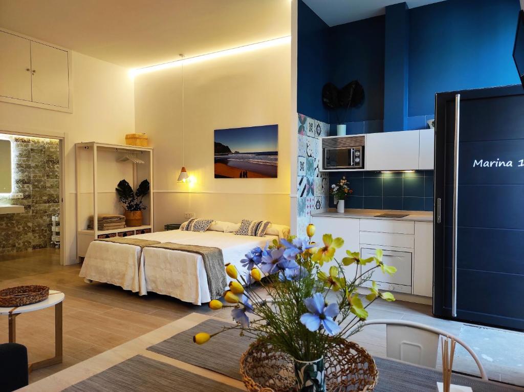 a large bedroom with a bed and a kitchen at Kaixo MARINA in Zarautz