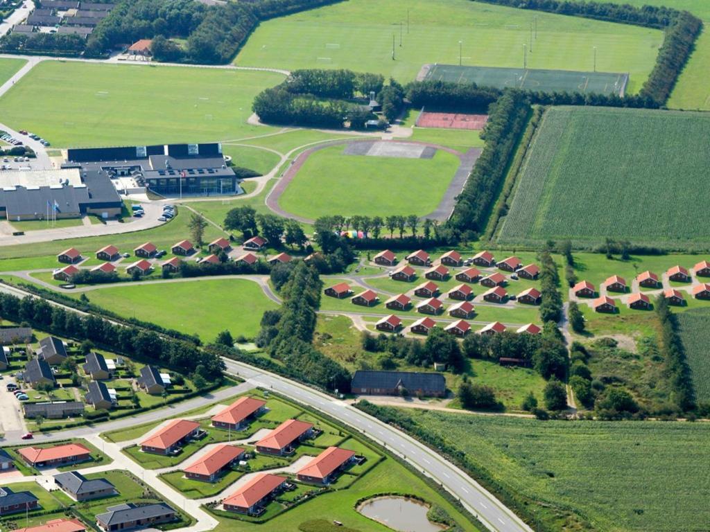 an aerial view of a village with houses and a road at 6 person holiday home in Sk rb k in Skærbæk