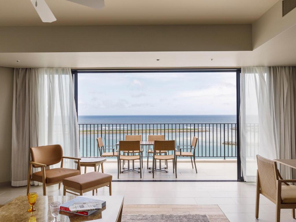 a dining room with a view of the ocean at MB GALLERY CHATAN by THE TERRACE HOTELS in Chatan