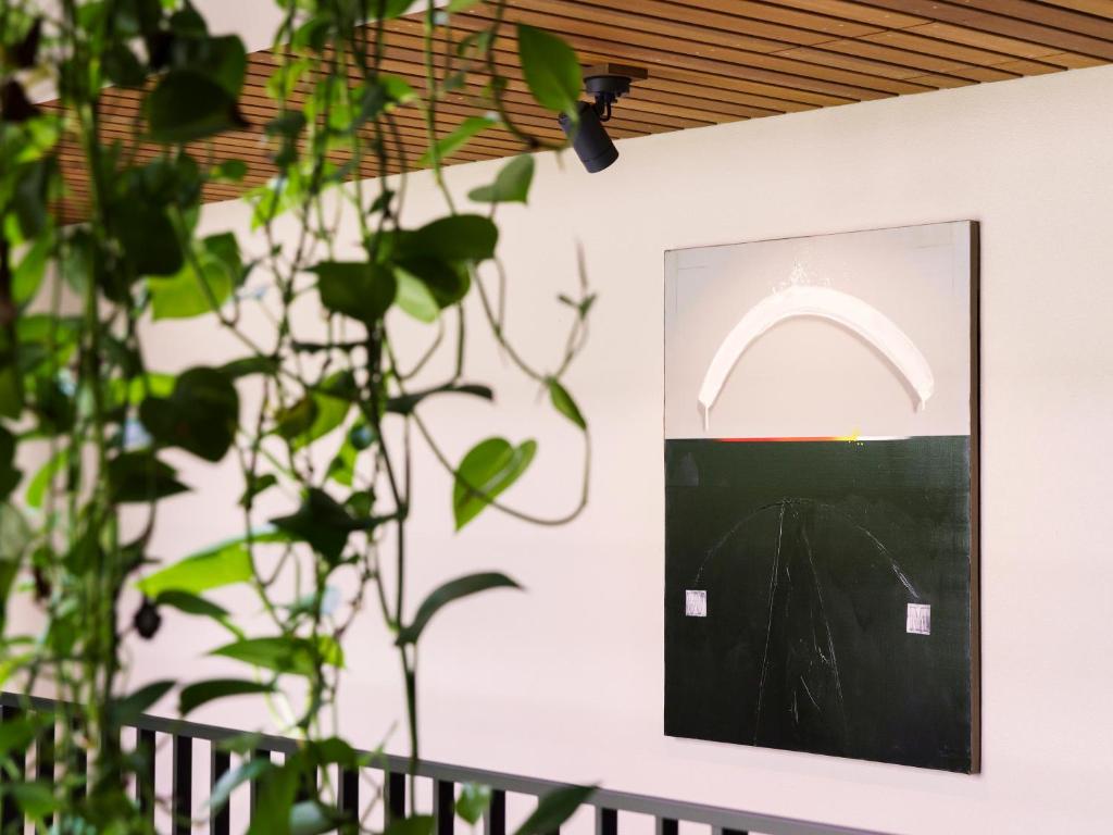 a picture of a arch on a wall next to a plant at MB GALLERY CHATAN by THE TERRACE HOTELS in Chatan