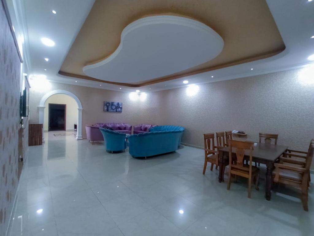 a room with a table and chairs and a couch at Flamingo Beach Hotel in Umm Al Quwain
