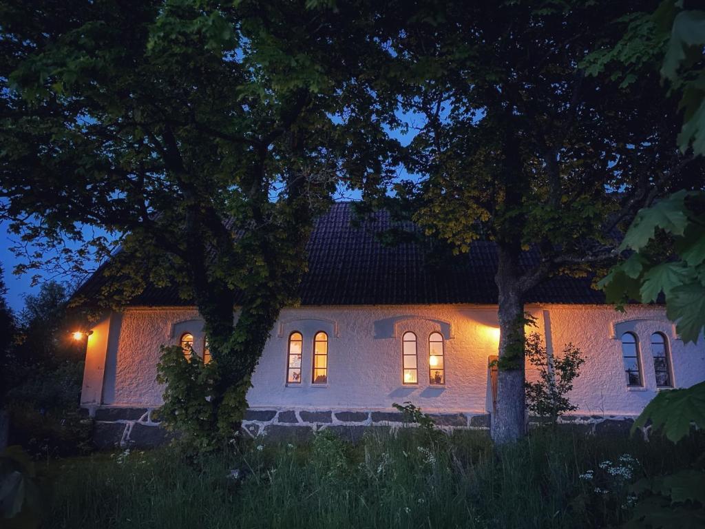 a house lit up at night with lights on at Gladeholm - Kivik - artist studio in Kivik