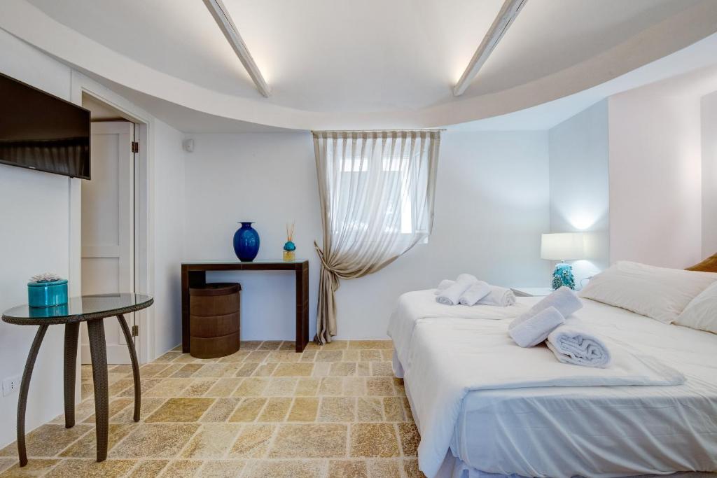 Postel nebo postele na pokoji v ubytování B&B Trulli Moonlight da Grace