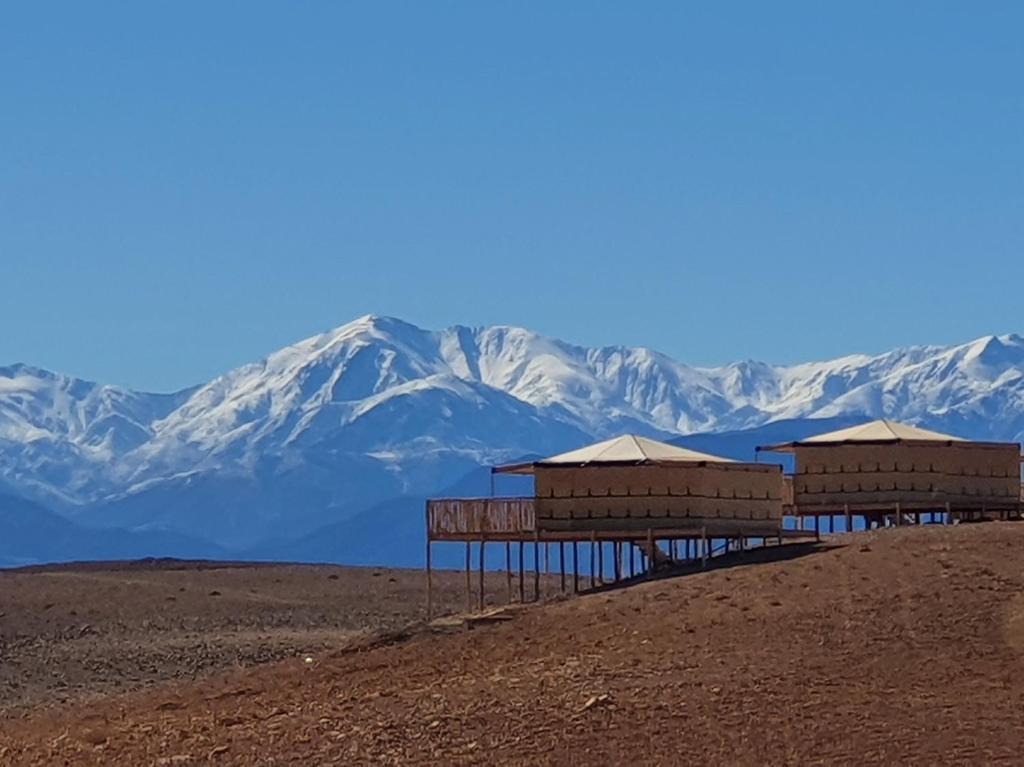 a group of huts on top of a mountain at Nkhila Lodge in Marrakech