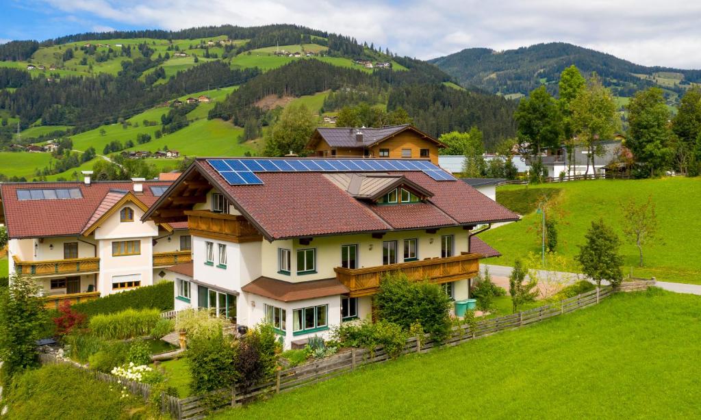 a house with solar panels on its roof at Berghoam - inklusive Wasserwelt in Wagrain