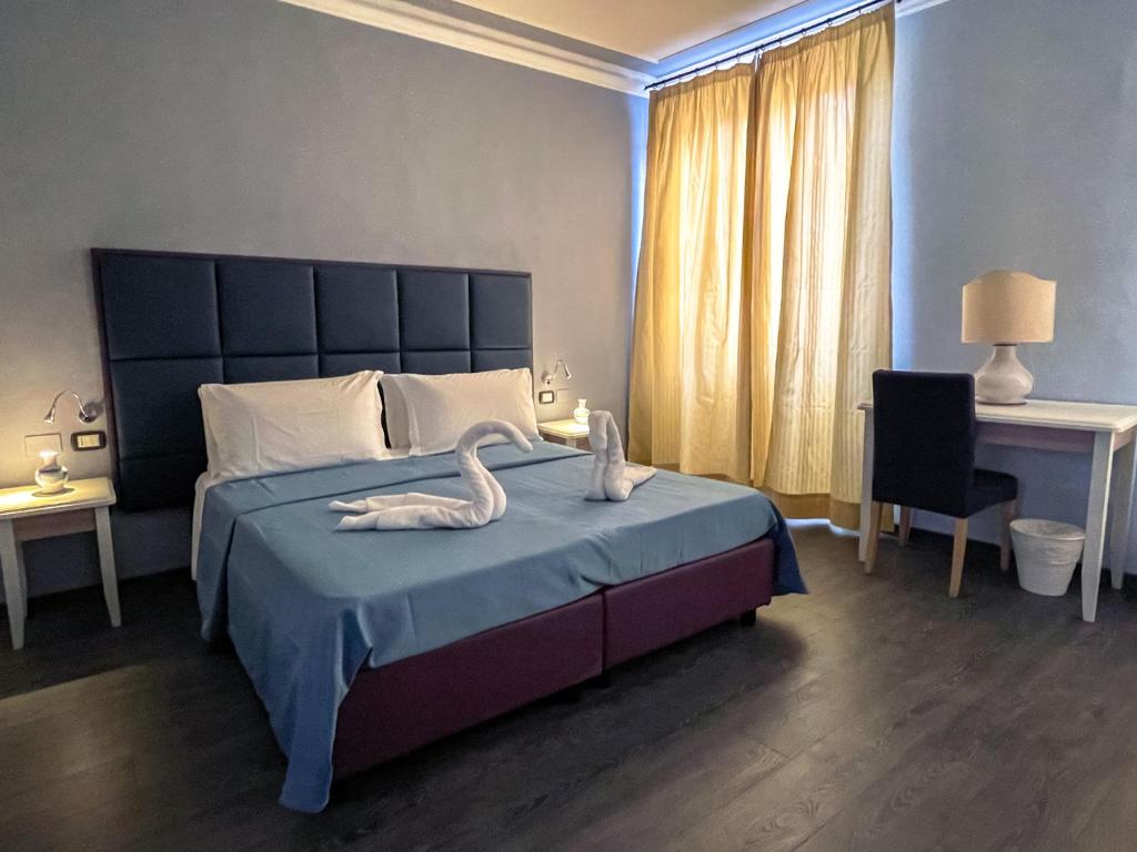 ein Schlafzimmer mit einem Bett mit zwei Schwänen darauf in der Unterkunft Hotel Gioia in Florenz