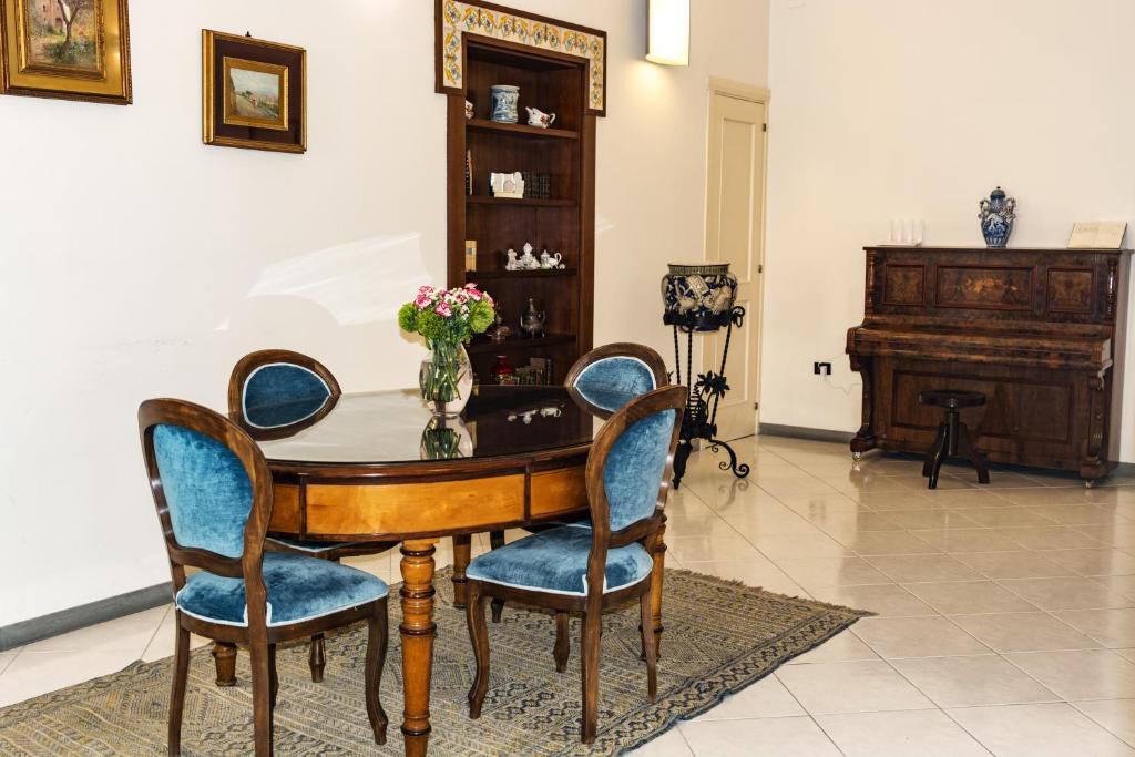 ナポリにあるSuite Filangieriのダイニングルーム(テーブル、椅子、ピアノ付)