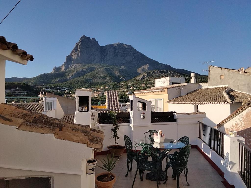 balkon ze stołem i krzesłami oraz góry w obiekcie CASA RURaL BENIDORM FINESTRAT EL CAPRICHO w mieście Finestrat