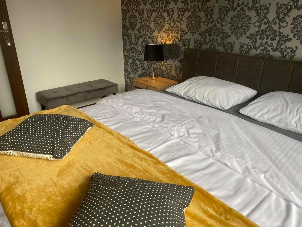 Posteľ alebo postele v izbe v ubytovaní Apartamenty Pod Jesionem