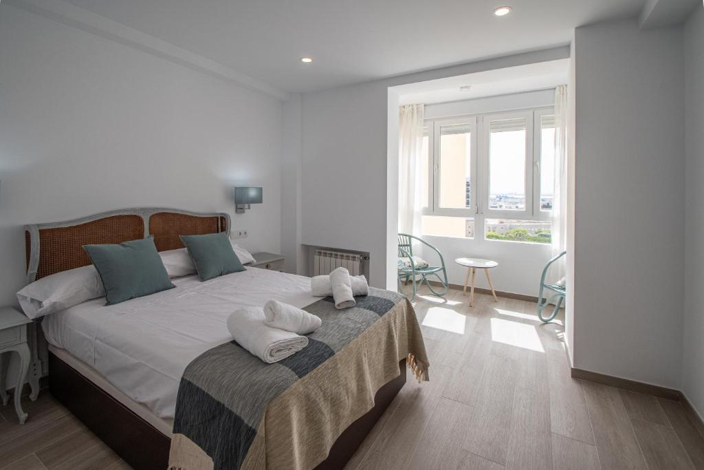 a bedroom with a large bed with pillows on it at Nuevo Mirandilla Apartment - Cadiz Beach in Cádiz