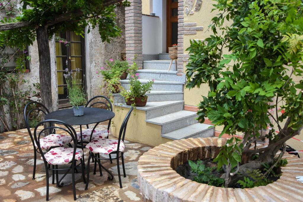 a patio with a table and chairs and stairs at ELBA Borgo di Latrano in Magazzini