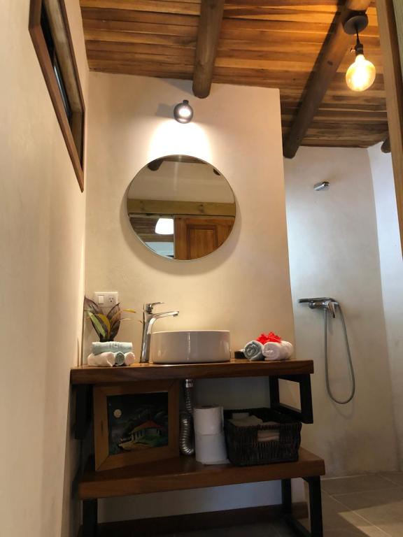 a bathroom with a sink and a mirror at Ginger Studio in Santa Teresa Beach