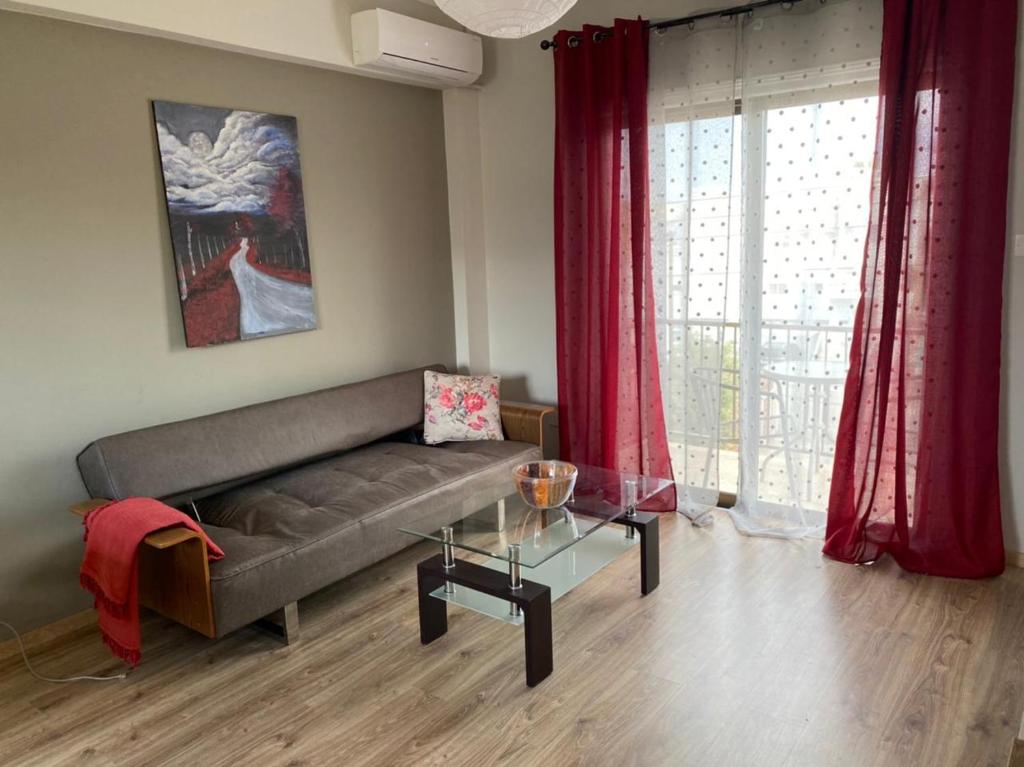 a living room with a couch and a glass table at ANDREAS APARTMENTS in Voroklini