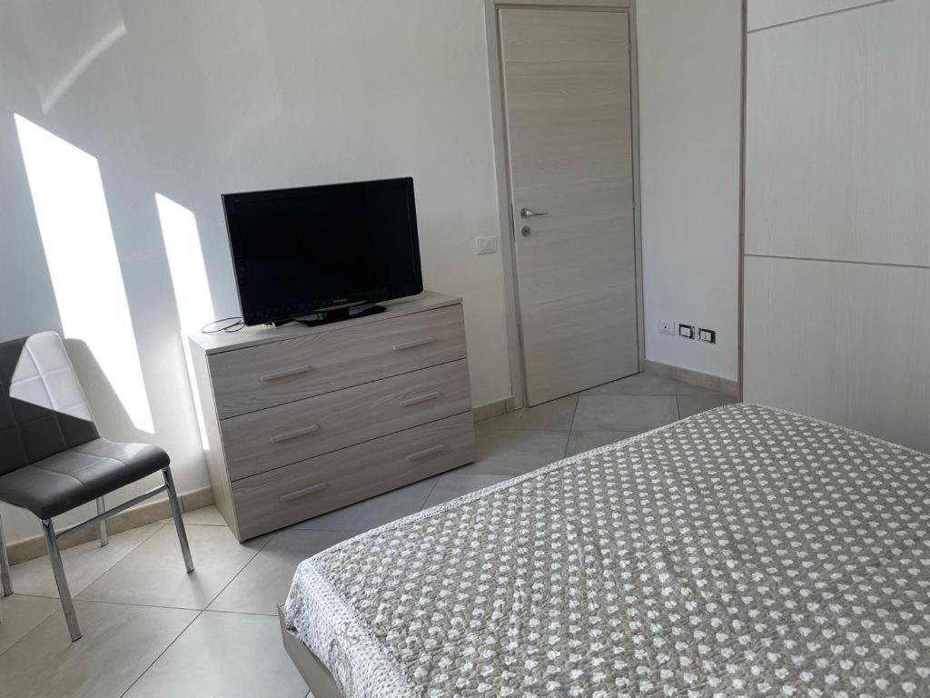 a bedroom with a bed and a television on a dresser at Appartamento a 400mt dal mare in Cecina