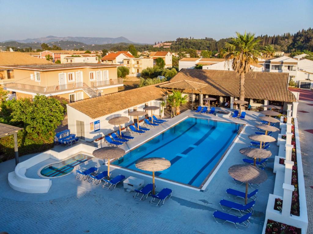 an overhead view of a pool with chairs and umbrellas at Corfu SunGate Hotel in Sidari