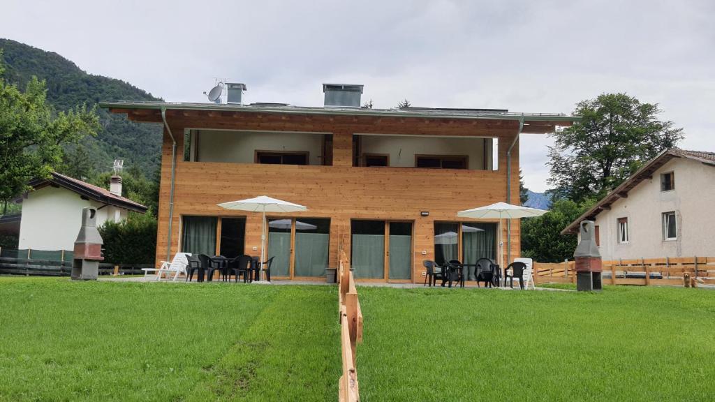 a house with a green lawn in front of it at Casa GABRI in Ledro