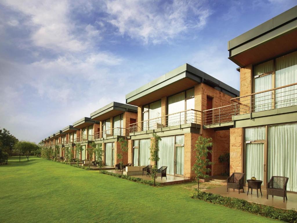 a row of buildings with a lawn in front at The Gateway Resort Damdama Lake in Gurgaon