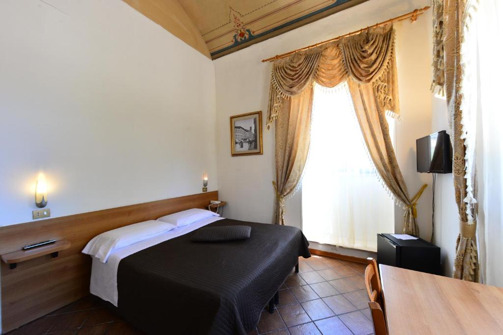 Postel nebo postele na pokoji v ubytování Hotel Iris
