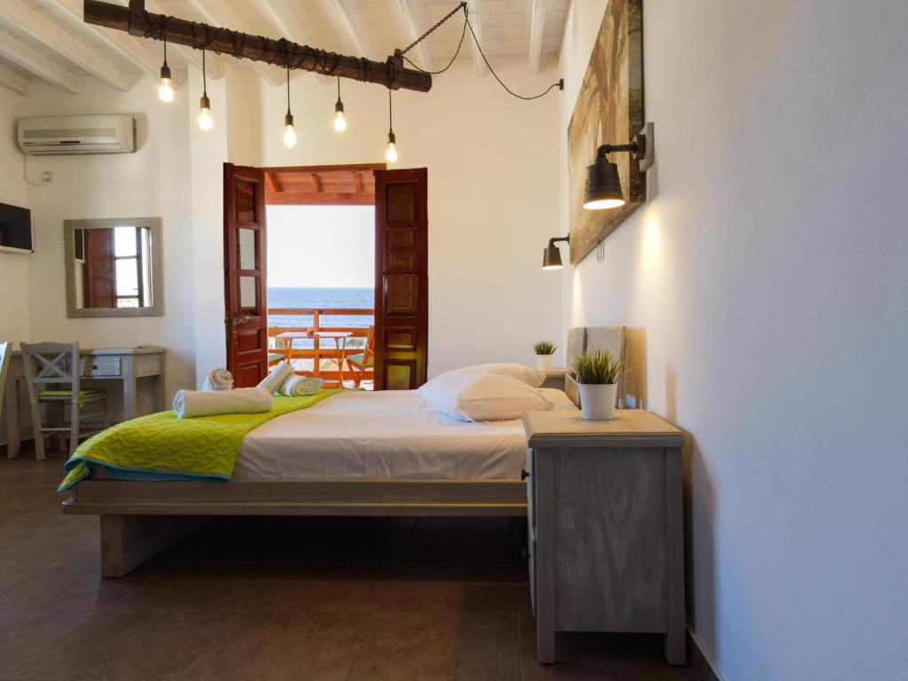 a bedroom with a bed with a view of the ocean at Mistral-Patmos in Patmos
