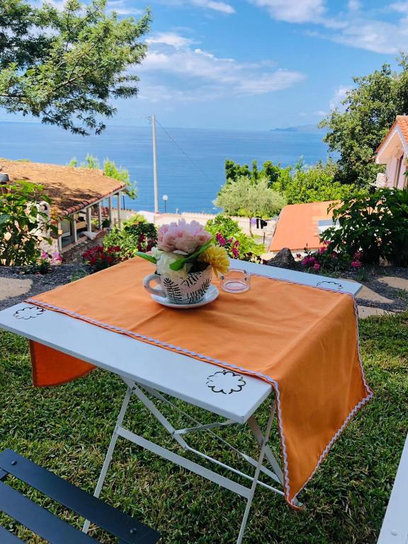 a table with a vase of flowers on it at Villa Alessandra in Maratea