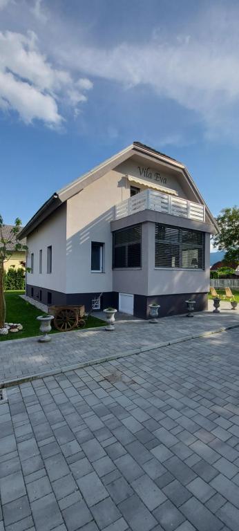 a white building with a sign on the side of it at Vila Eva Lesce - Bled in Lesce