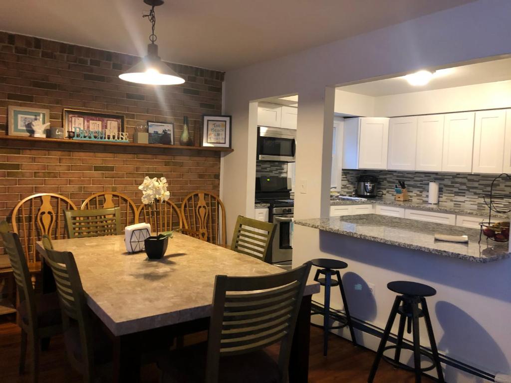 a kitchen and dining room with a table and chairs at The Best of the Jersey Shore #airbnb in Long Branch