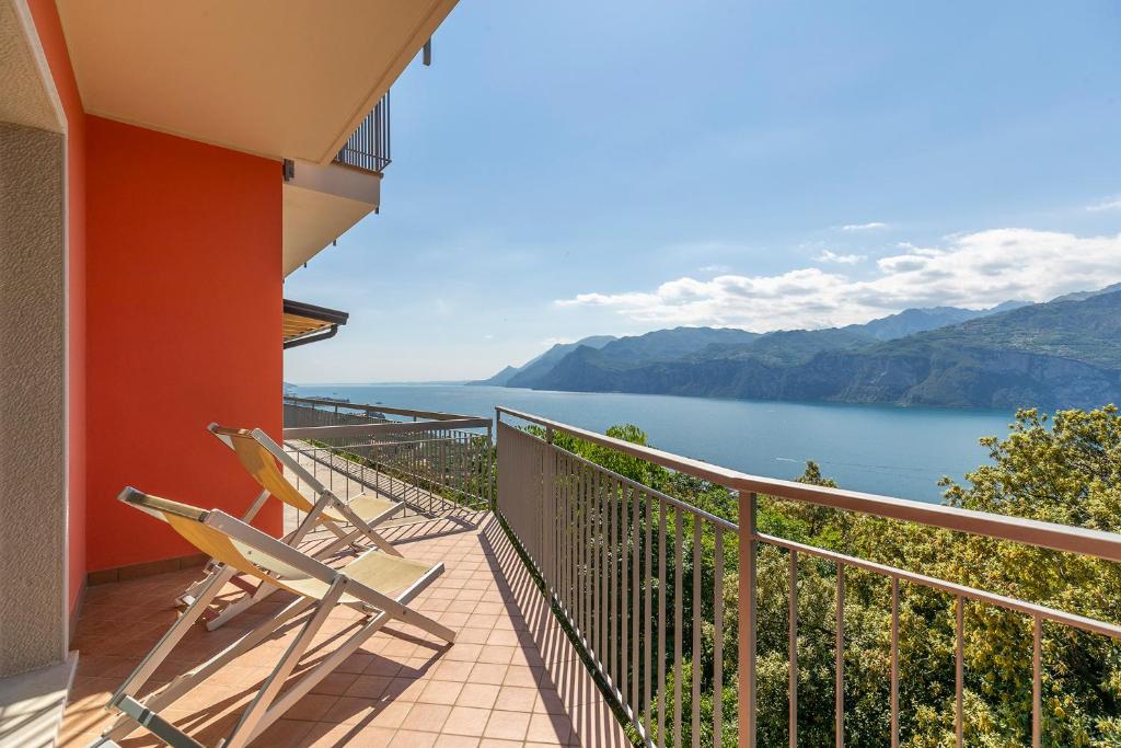 a balcony with two chairs and a view of the water at Casa Prea Apartments in Malcesine