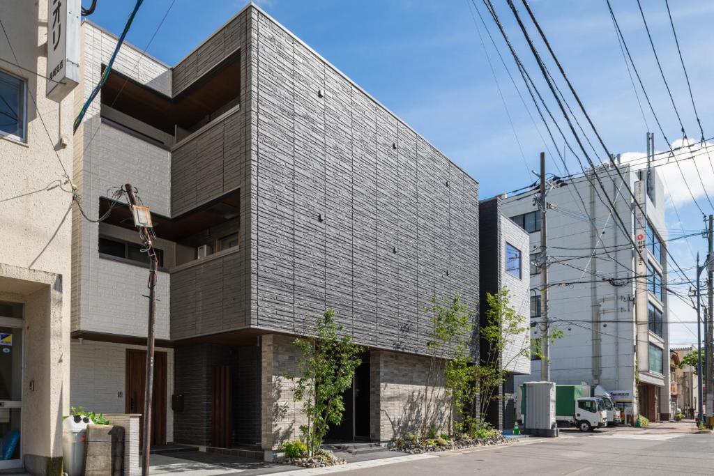 a building clad in black brick at GRAND BASE Saiwaimachi in Nagasaki