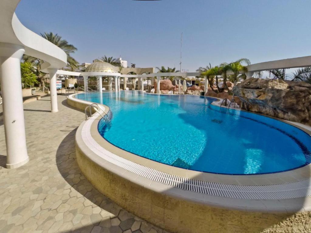 a large swimming pool in a resort at EILAT GOLF RESIDENCE Apartment A 1 in Eilat