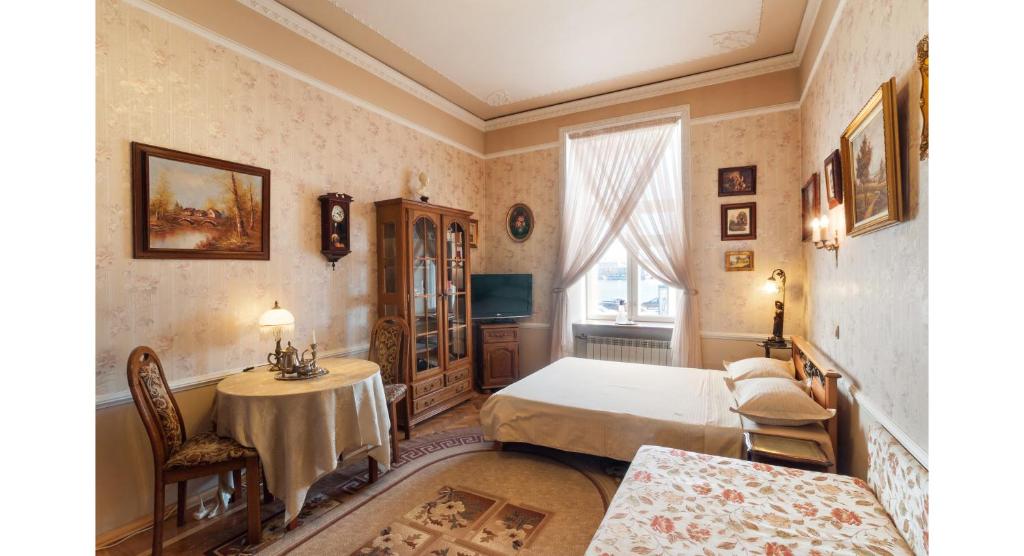 a bedroom with a bed and a table at View on Neva in Saint Petersburg