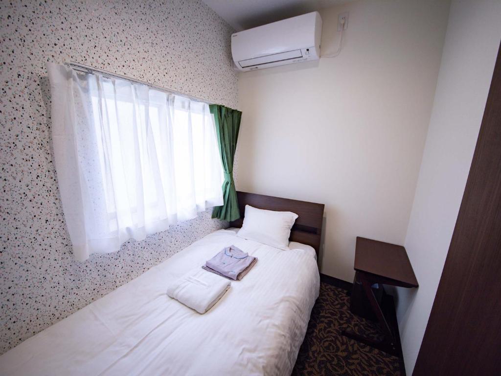 Postel nebo postele na pokoji v ubytování tune HIGORO