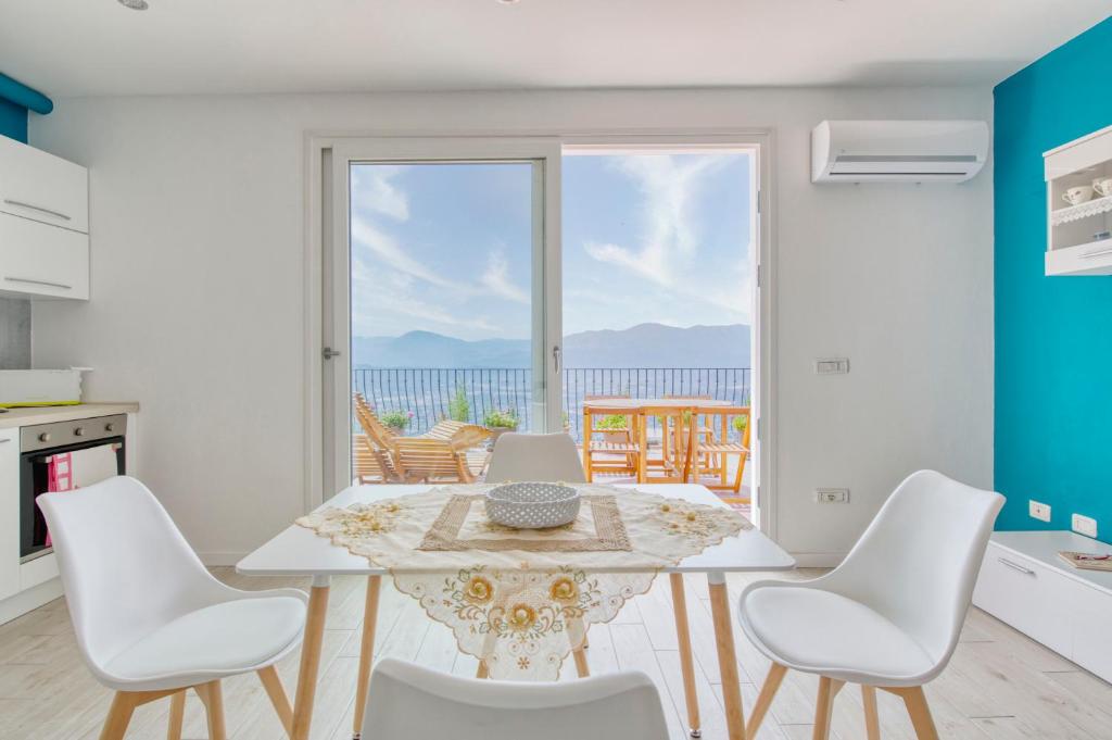 a kitchen with a table and chairs and a view of the ocean at Gorropu Guest House in Baunei