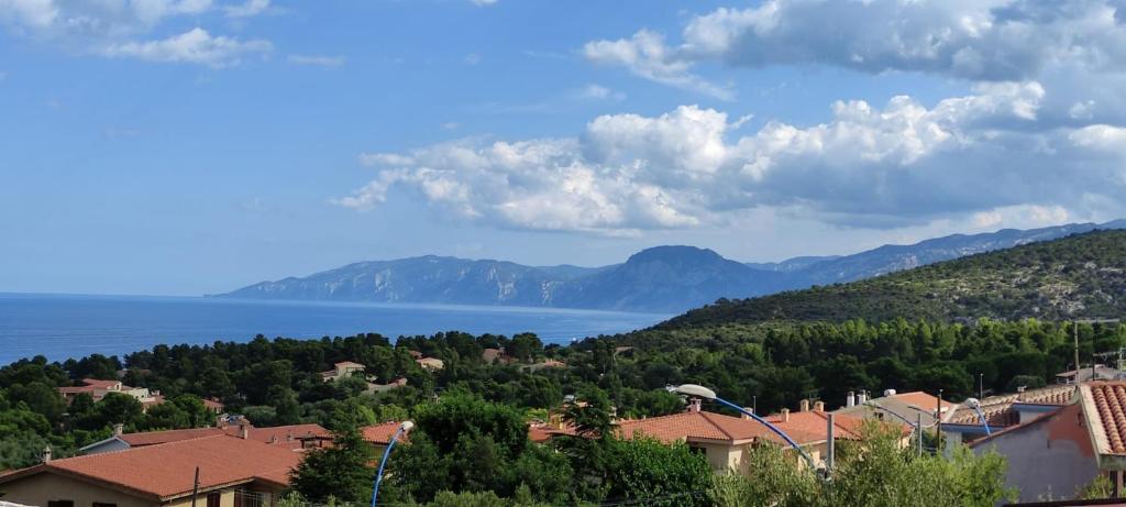 a town with a view of the lake and mountains at Casa Lucia Relax in Cala Gonone