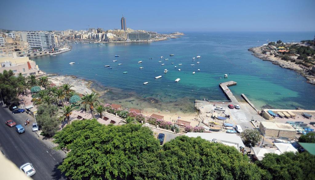 a view of a beach with boats in the water at Carlton Hotel in Sliema