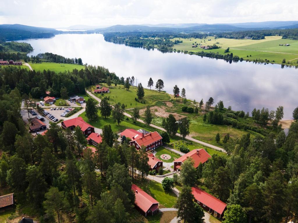 an aerial view of a building next to a body of water at Camp Järvsö Hotell in Järvsö