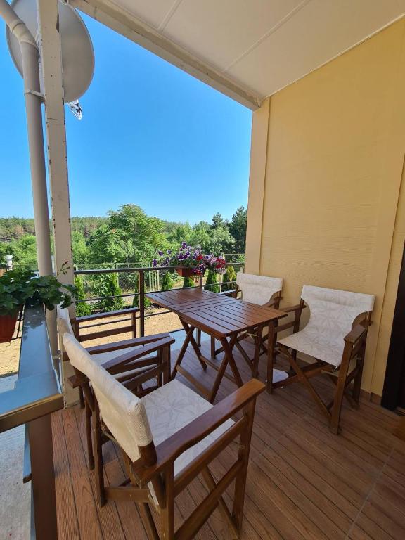 a patio with a table and chairs on a balcony at Бунгала Калина - Нестинарка in Tsarevo