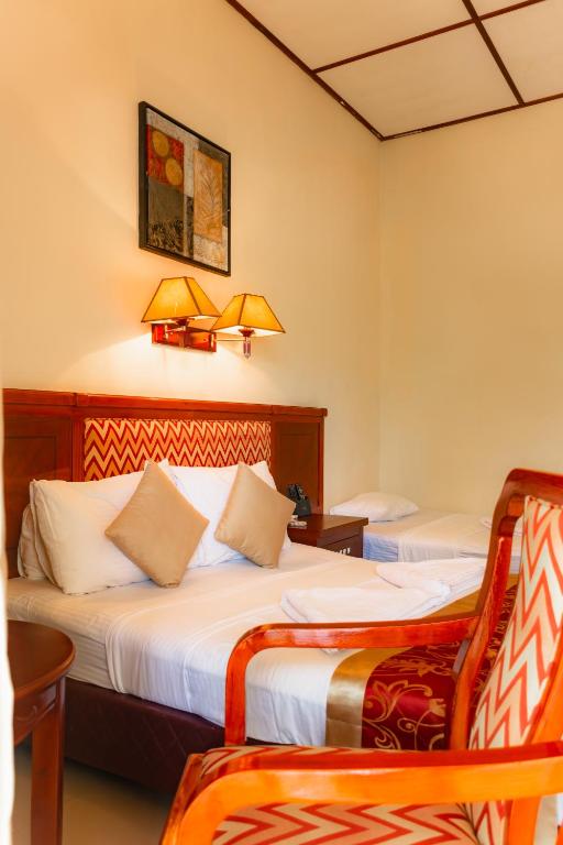 Postel nebo postele na pokoji v ubytování Heritage Hotel