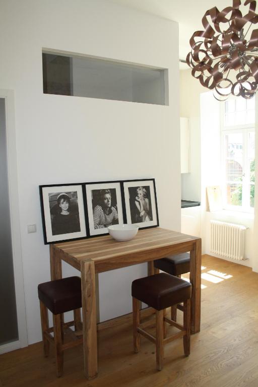 a dining room table with two chairs and a chandelier at Apartment 1 in Mannheim