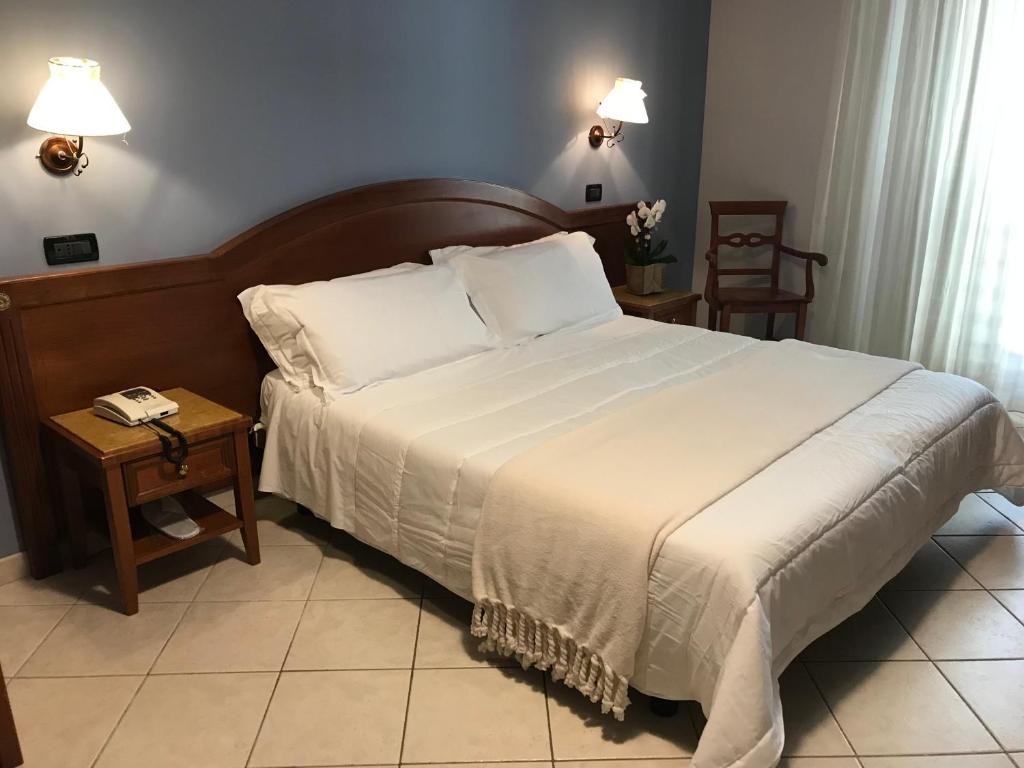Postel nebo postele na pokoji v ubytování Hotel Parco Delle Rose